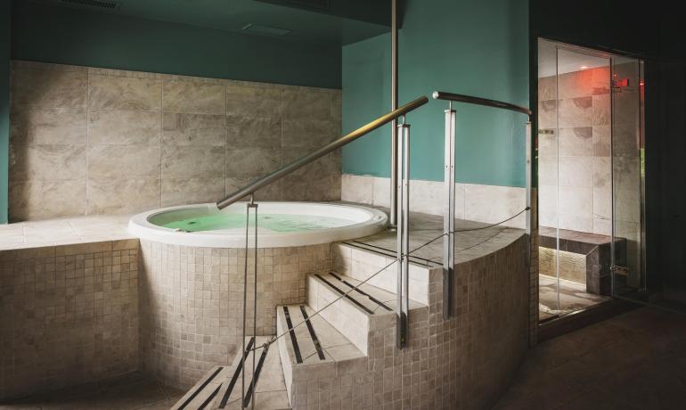 Hot tub with shower in a modern spa.